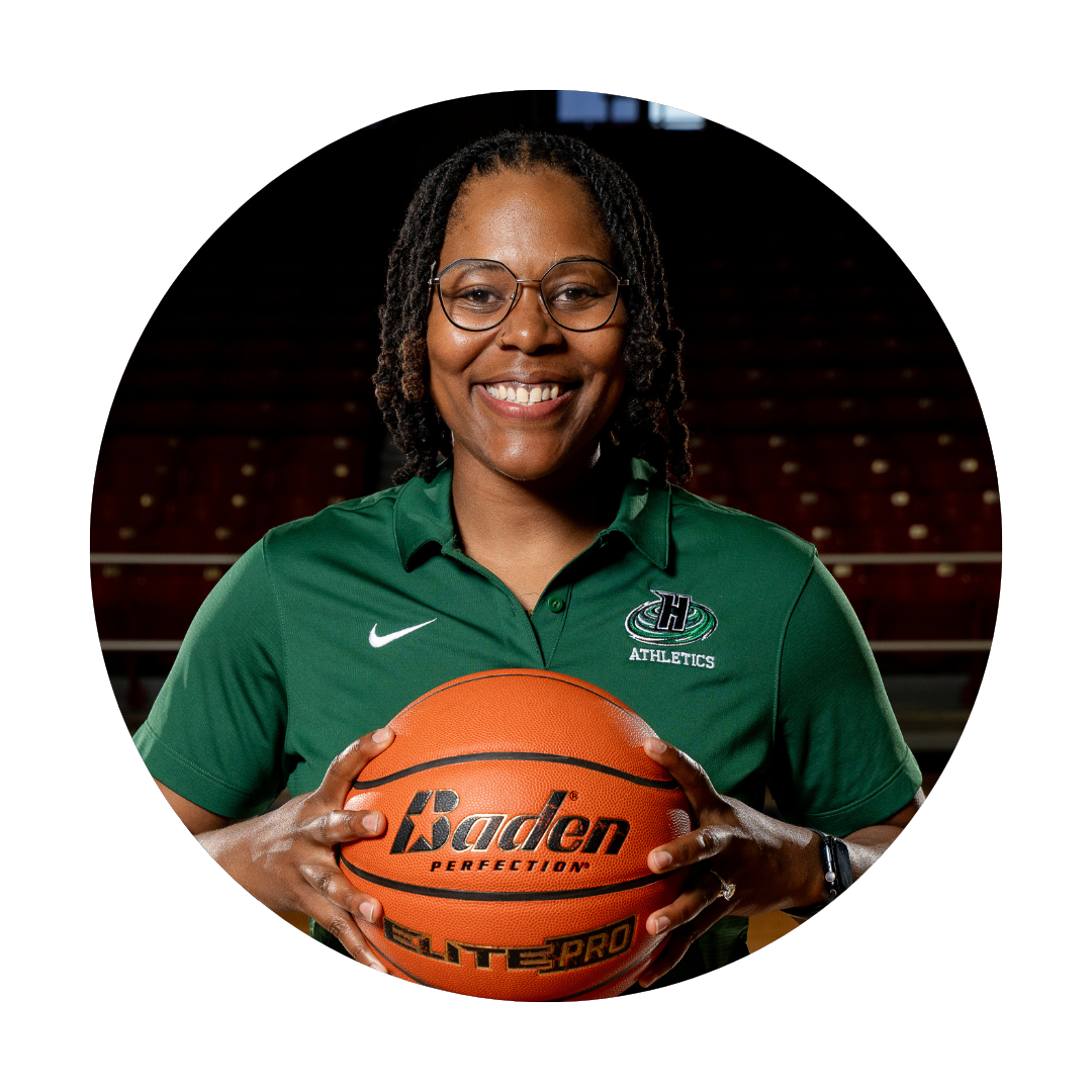 Hightower Coach Jasmine Brewer smiling with basketball