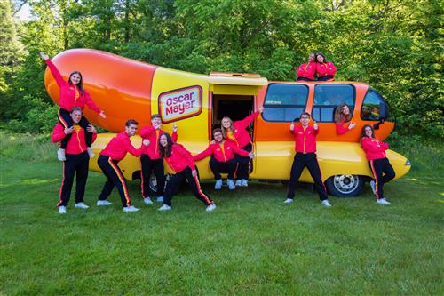 Hotdoggers posing in front of Weinermobile