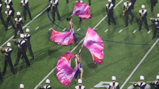  Two Color Guard students with Marching Band