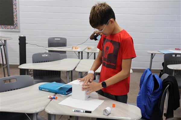 Safety First. With a look of determination, Hayden assembles his tissue box camera for his camera safety project. Yearbook staffers were required to carry their practice cameras from class to calls for a week to prove responsibility 