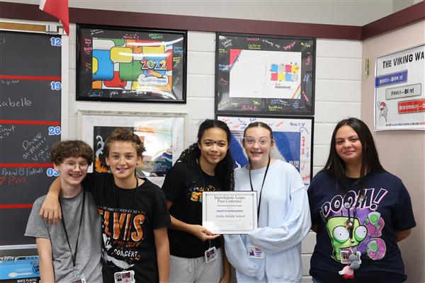 Hard Work Pays Off  After a year of commitment to the journalistic process, second-year staffers celebrate prestigious recognition from the Interscholastic League Press Conference. The Dulles Middle School Sixtieth Anniversary Yearbook earned an Award of Achievement, an honor reserved for publicatio