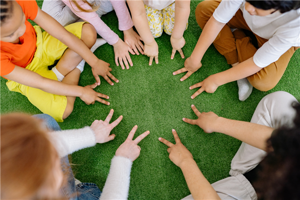 Young children hands touching together forming a circle